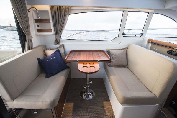 Slide: The Image of Interior of 2025 Nimbus 305 Coupe with cozy seating and wooden table. - 4