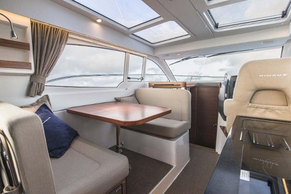 Slide: The Image of Interior of 2025 Nimbus 305 Coupe with dining area and panoramic windows. - 5