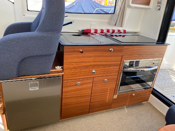 Slide: The Image of Interior of 2025 Nimbus 305 Coupe with modern kitchen and seating area. - 7