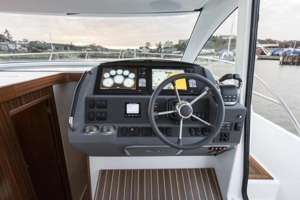 Slide: The Image of 2025 Nimbus 405 Coupé helm station with modern navigation instruments. - 8