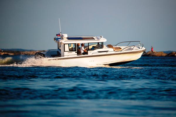 Slide: The Image of Nimbus C9 2025 model boat cruising on open water. - 0