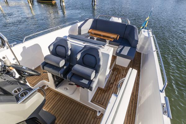 Slide: The Image of Nimbus T9 2025 boat interior with seating and wooden deck. - 1