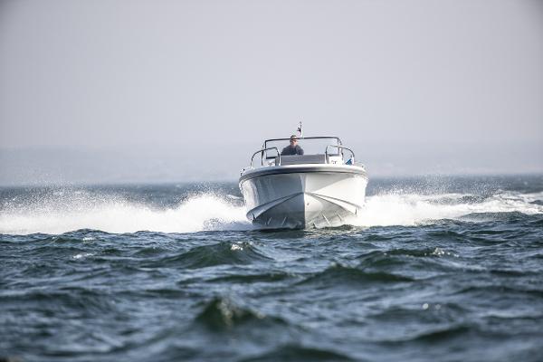 Slide: The Image of 2025 Nimbus T9 boat cruising on open water. - 8