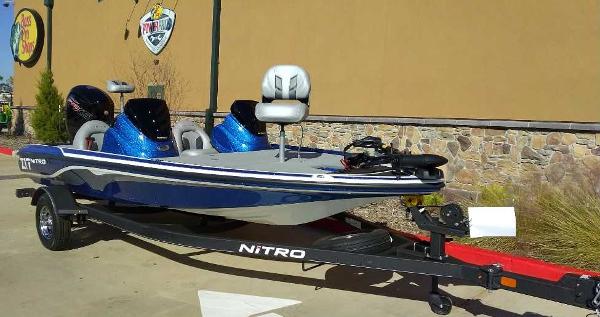 Slide: The Image of 2024 Nitro Z17 fishing boat on trailer, blue and white, parked outdoors. - 3