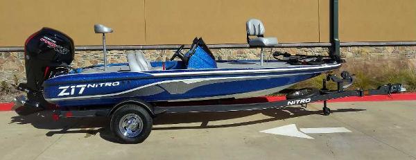 Slide: The Image of 2024 Nitro Z17 fishing boat with trailer, blue and white design. - 4