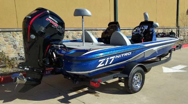 Slide: The Image of 2024 Nitro Z17 fishing boat with trailer, blue exterior, and powerful outboard motor. - 5