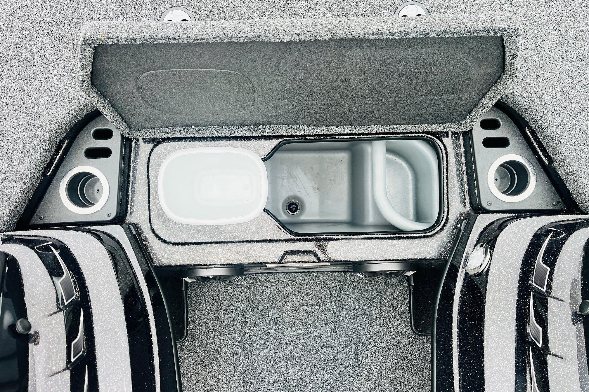 Slide: The Image of 2021 Nitro Z19 Pro boat storage compartment with open lid and cup holders. - 30