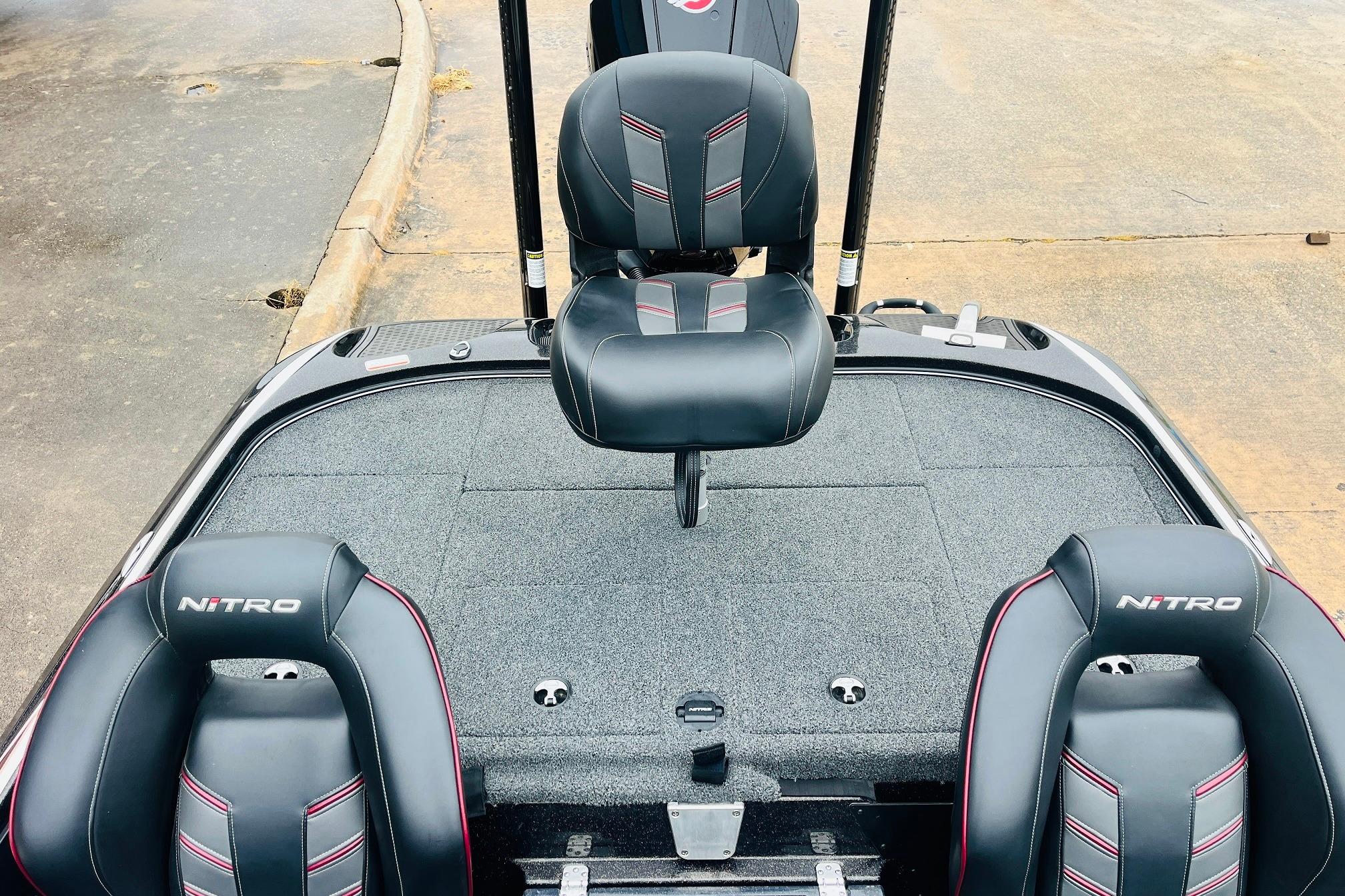 Slide: The Image of 2021 Nitro Z19 Pro boat interior with black and red seats on a gray deck. - 43