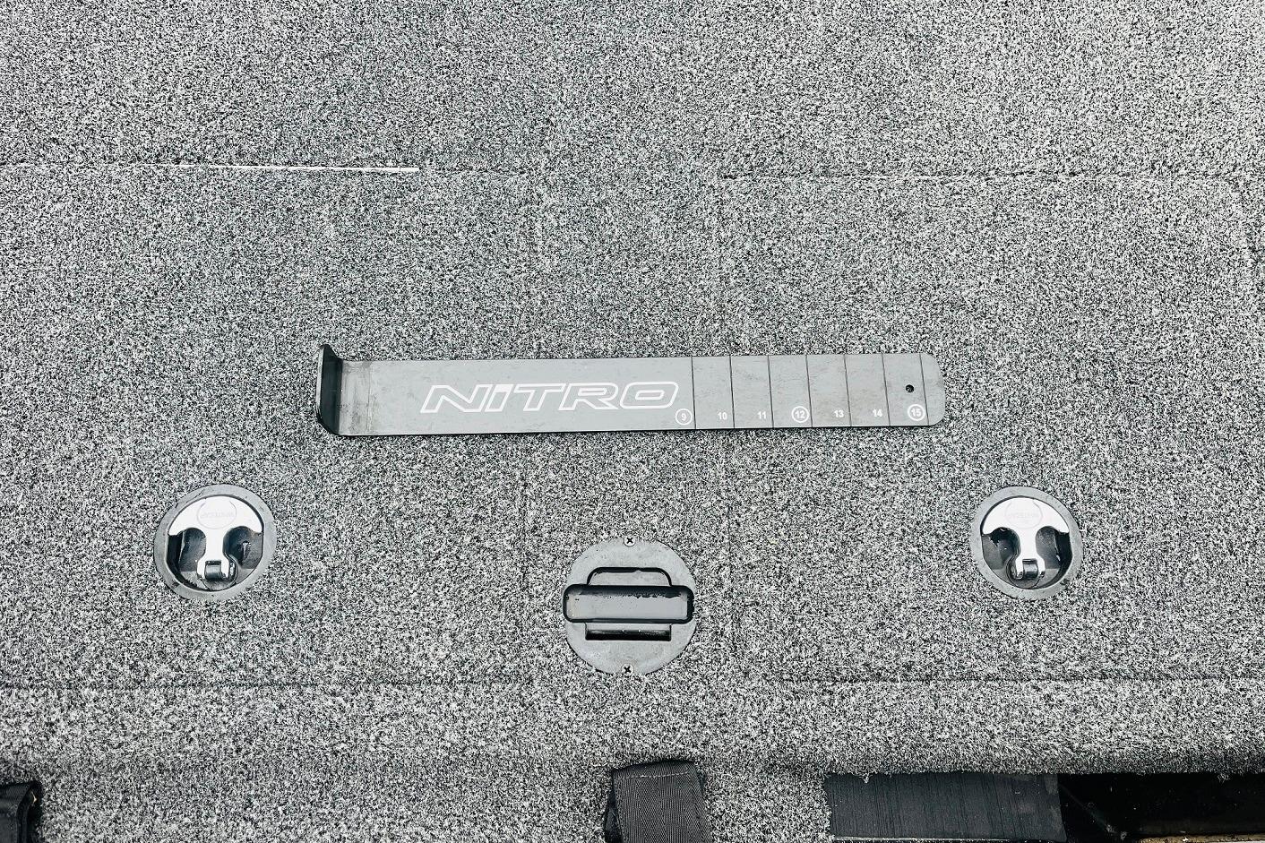 Slide: The Image of 2021 Nitro Z19 Pro boat deck with measurement tool and storage latches. - 48