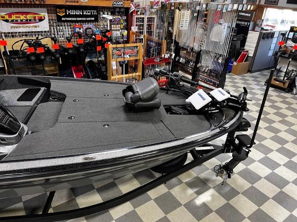 Slide: The Image of 2023 Nitro Z19 Pro fishing boat displayed in a showroom with fishing gear. - 3