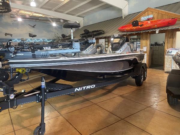 Slide: The Image of 2024 Nitro Z19 Pro boat displayed in showroom with kayaks in the background. - 0