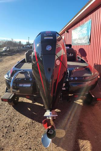 Slide: The Image of 2024 Nitro Z19 Pro boat with outboard motor, parked near a red building. - 6