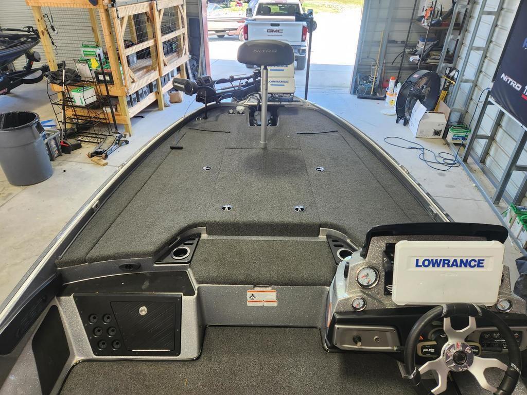 Slide: The Image of 2022 Nitro Z20 boat interior with Lowrance electronics in a garage setting. - 8
