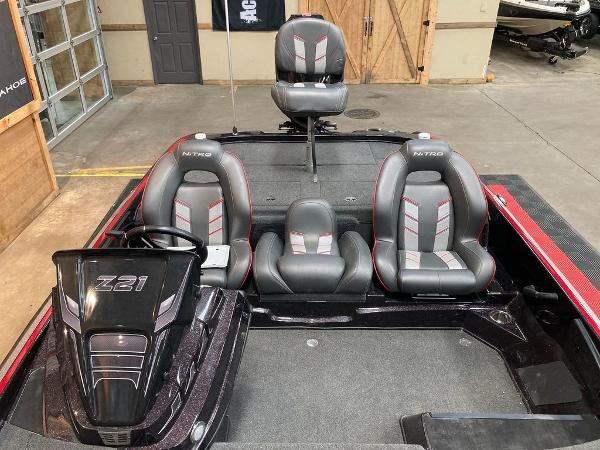 Slide: The Image of 2021 Nitro Z21 Pro boat interior with three seats in a showroom. - 2