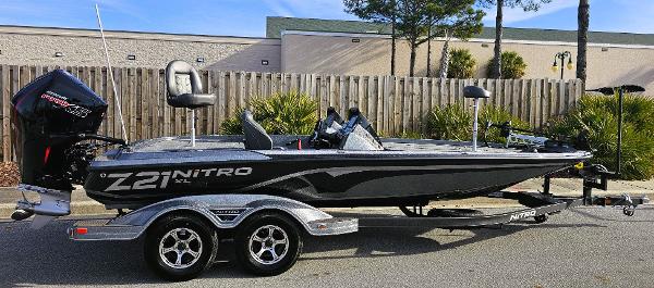 Slide: The Image of 2024 Nitro Z21 XL fishing boat on a trailer, parked outdoors. - 0