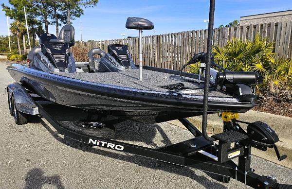 Slide: The Image of 2024 Nitro Z21 XL bass fishing boat on trailer, parked outdoors. - 3