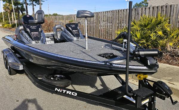 Slide: The Image of 2024 Nitro Z21 XL fishing boat on trailer, parked outdoors. - 7