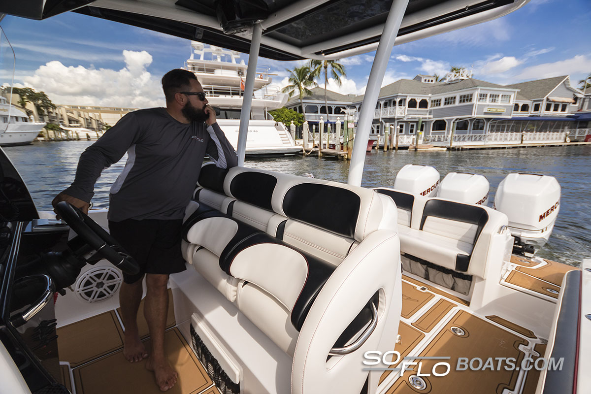 Slide: The Image of 2024 Nor-Tech 340 Sport Center Console boat with a man at the helm. - 10