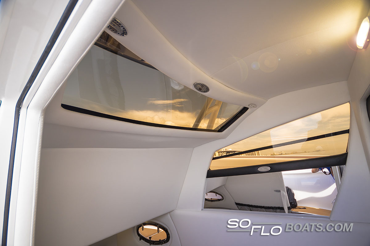 Slide: The Image of Interior view of 2024 Nor-Tech 340 Sport Center Console with skylights and modern design. - 11
