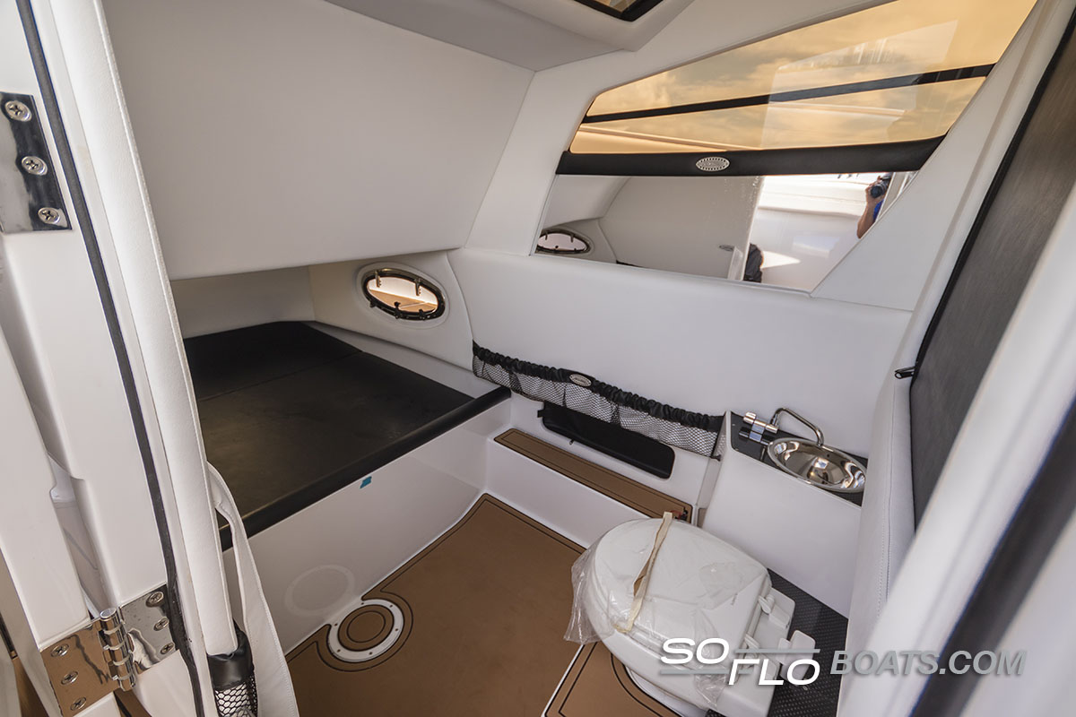 Slide: The Image of Interior cabin of 2024 Nor-Tech 340 Sport Center Console boat with toilet and sink. - 12