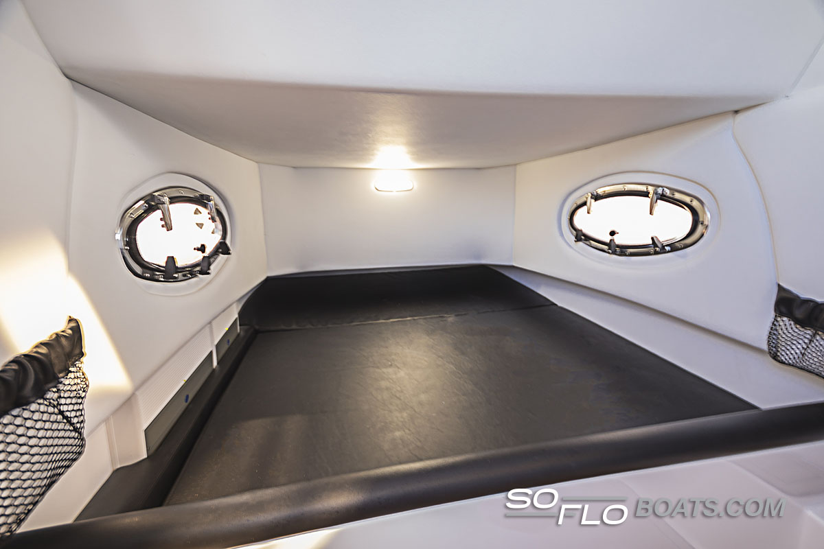 Slide: The Image of Interior cabin of 2024 Nor-Tech 340 Sport Center Console boat with portholes and lighting. - 13