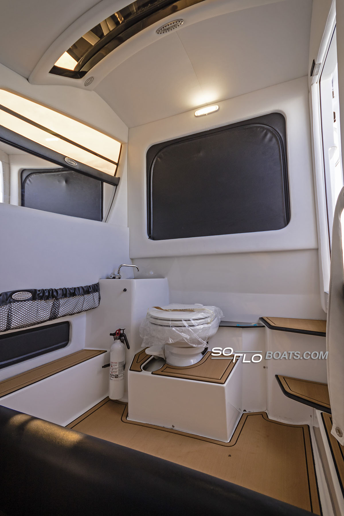 Slide: The Image of Interior of 2024 Nor-Tech 340 Sport Center Console boat with toilet and sink. - 14