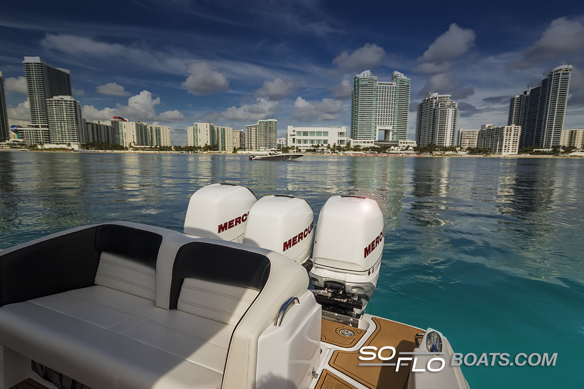 Slide: The Image of 2024 Nor-Tech 340 Sport Center Console boat with Mercury engines, city skyline in background. - 15