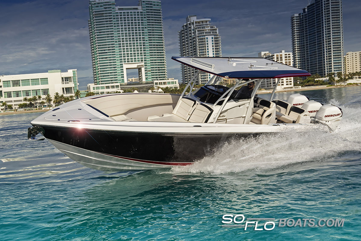 Slide: The Image of 2024 Nor-Tech 340 Sport Center Console boat cruising near modern cityscape. - 3