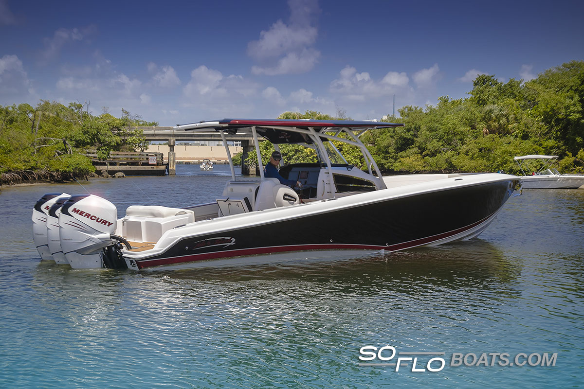 Slide: The Image of 2024 Nor-Tech 340 Sport Center Console boat on water with triple Mercury engines. - 4