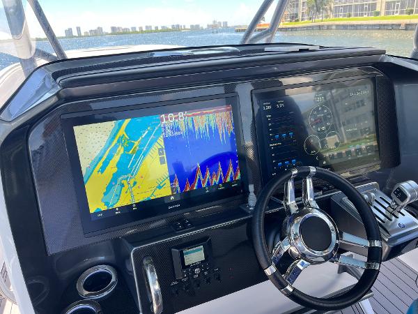 Slide: The Image of 2023 Nor-Tech 340 Sport boat dashboard with navigation and control screens. - 5