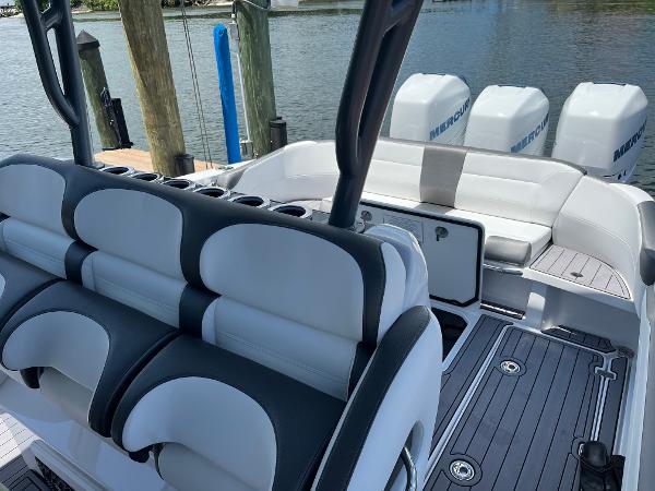 Slide: The Image of 2023 Nor-Tech 340 Sport boat interior with seating and Mercury outboard engines. - 6