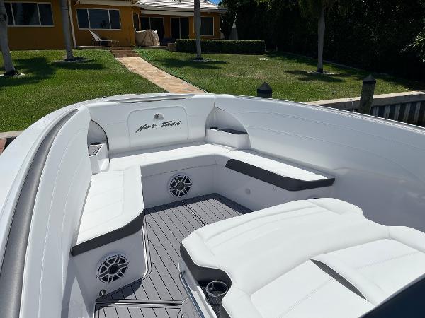 Slide: The Image of 2023 Nor-Tech 340 Sport boat with white seating and modern design. - 7