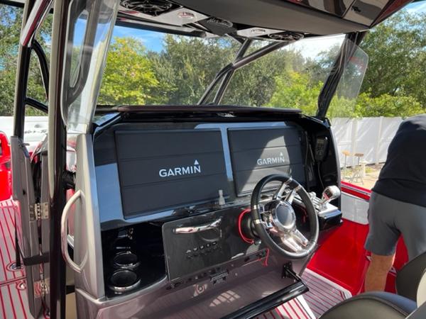 Slide: The Image of 2022 Nor-Tech 390 Sport Center Console helm with Garmin displays. - 5