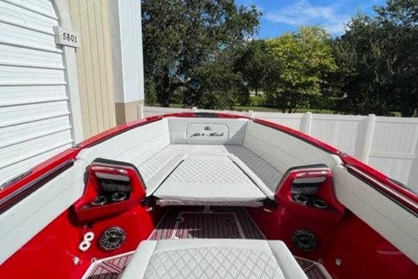 Slide: The Image of 2022 Nor-Tech 390 Sport Center Console boat with red and white interior. - 7