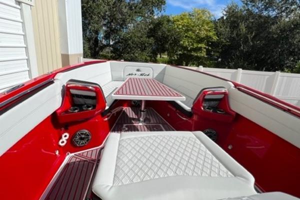 Slide: The Image of 2022 Nor-Tech 390 Sport Center Console boat with red and white interior. - 9