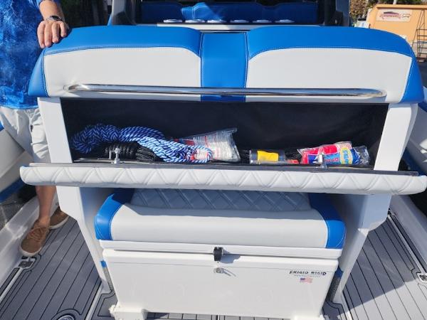 Slide: The Image of 2024 Nor-Tech 400 Supersport boat storage compartment with various items. - 4
