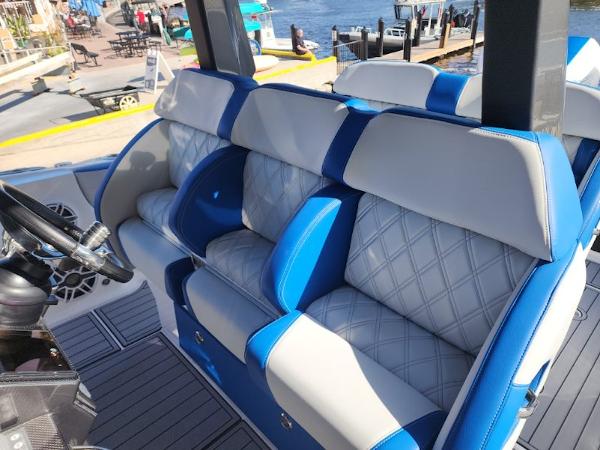 Slide: The Image of 2024 Nor-Tech 400 Supersport boat interior with blue and white seating. - 6