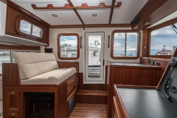 Slide: The Image of Interior of 2025 Nordic Tug 40 with wooden finish and large windows. - 11