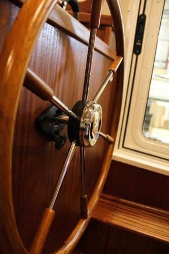 Slide: The Image of Wooden helm of 2025 Nordic Tug 40 boat near window. - 2