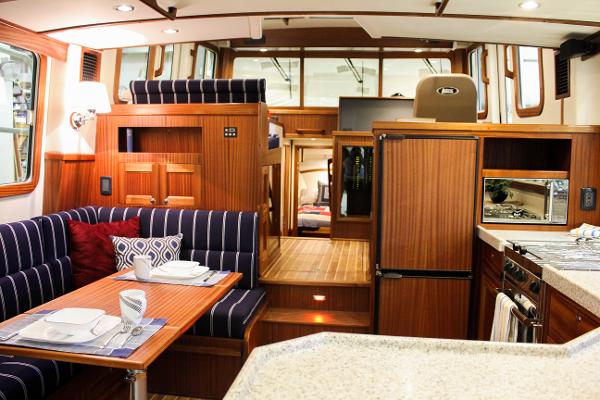 Slide: The Image of Interior of 2025 Nordic Tug 40 with modern kitchen and dining area. - 3