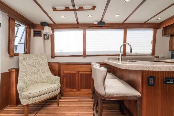 Slide: The Image of 2025 Nordic Tug 44 interior with elegant seating and modern kitchen area. - 4