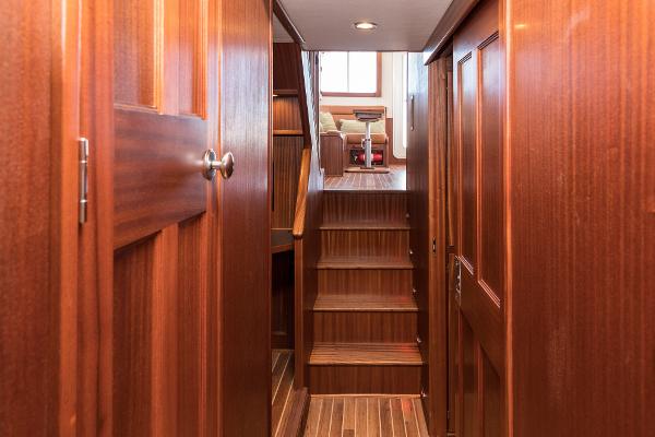 Slide: The Image of 2025 Nordic Tug 44 interior hallway with wooden stairs and doors - 5