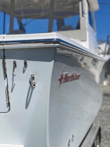 Slide: The Image of 2021 NorthCoast 315 HT boat side view with logo and chrome details. - 10