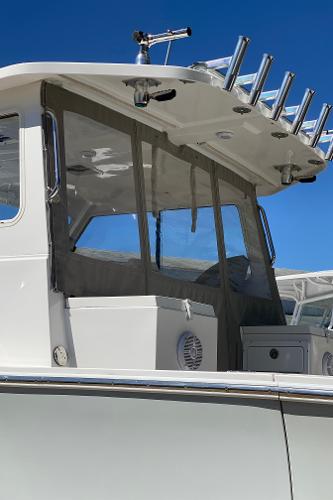 Slide: The Image of 2021 NorthCoast 315 HT boat with enclosed cabin and rod holders. - 17