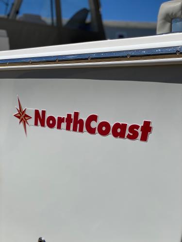Slide: The Image of 2021 NorthCoast 315 HT boat with red logo and white hull. - 22
