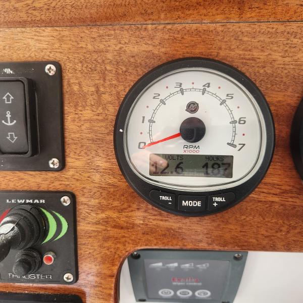 Slide: The Image of Close-up of NorthCoast 315 HT 2021 boat dashboard with RPM gauge and controls. - 24