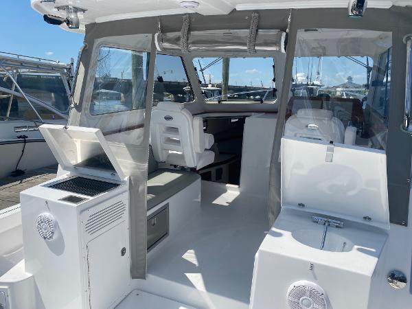 Slide: The Image of 2021 NorthCoast 315 HT boat interior with seating and storage compartments. - 6