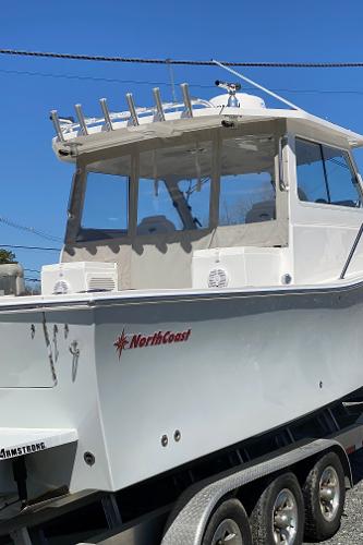 Slide: The Image of 2021 NorthCoast 315 HT boat on a trailer under a clear blue sky. - 9