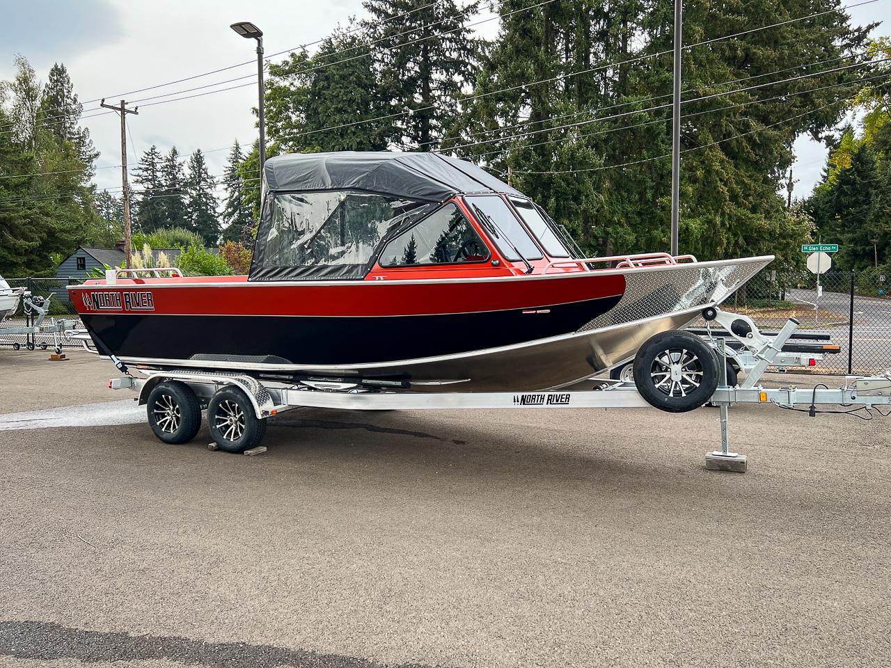 Slide: The Image of 2024 North River 23 SeaHawk boat on a trailer in a parking lot. - 1