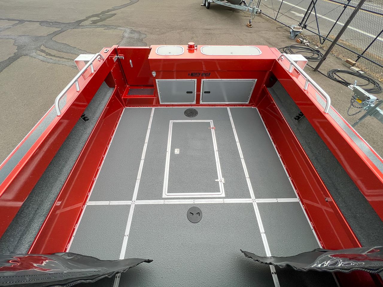 Slide: The Image of 2024 North River 23 SeaHawk boat interior, red and gray deck, spacious layout. - 14